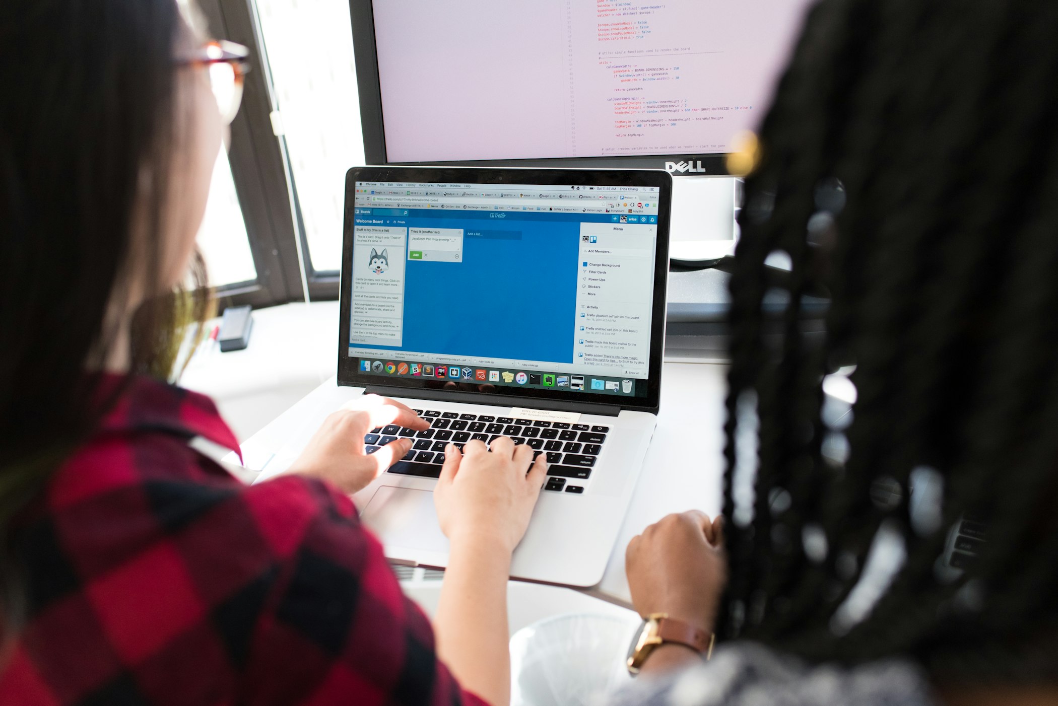 Two women looking at a laptop screen.