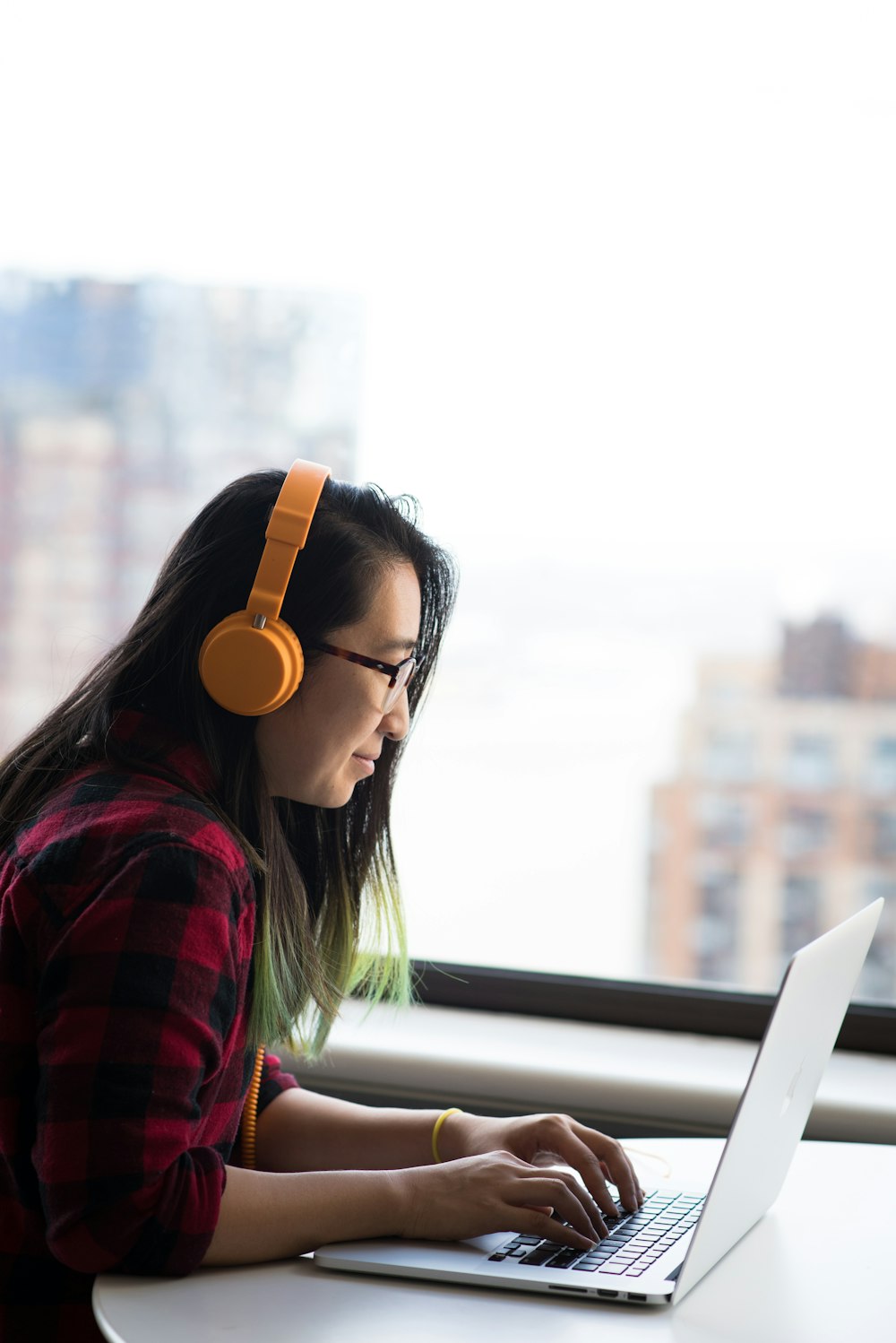 shallow focus photo of woman using gray laptop computer