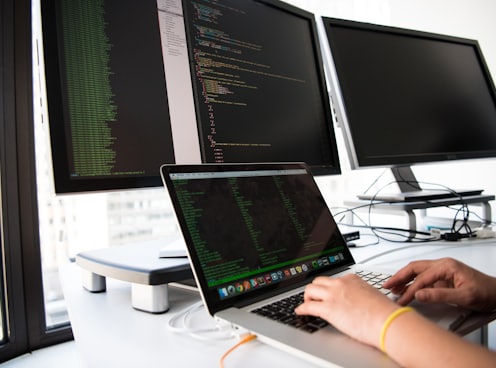 shallow focus photo of person using MacBook