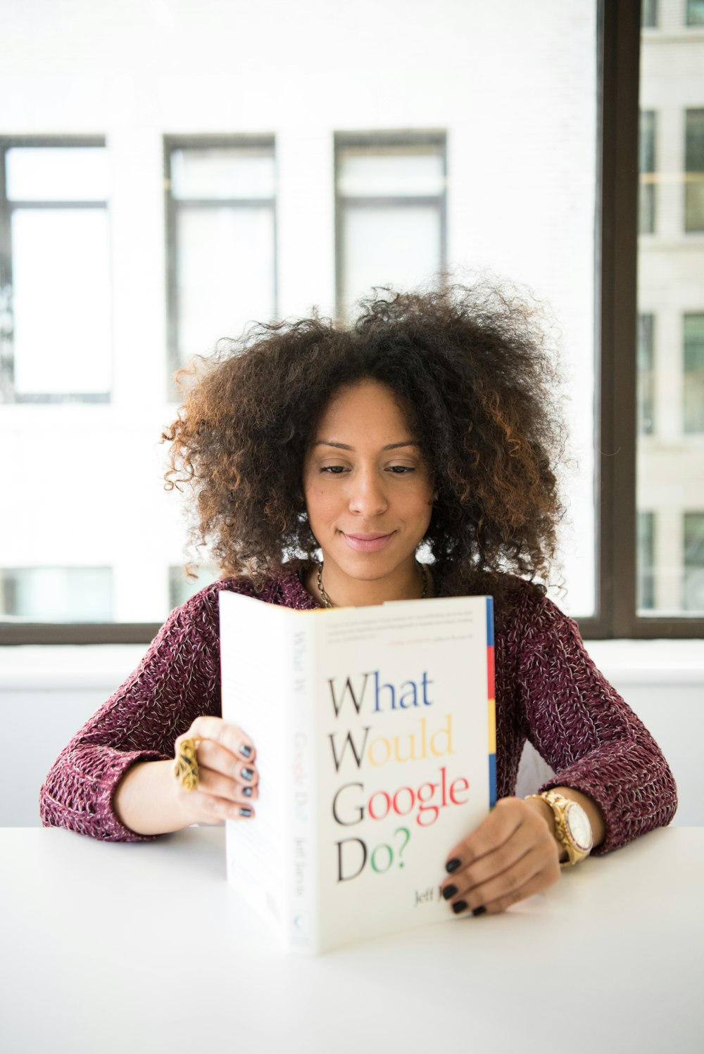 woman reading What Would Google Do? book