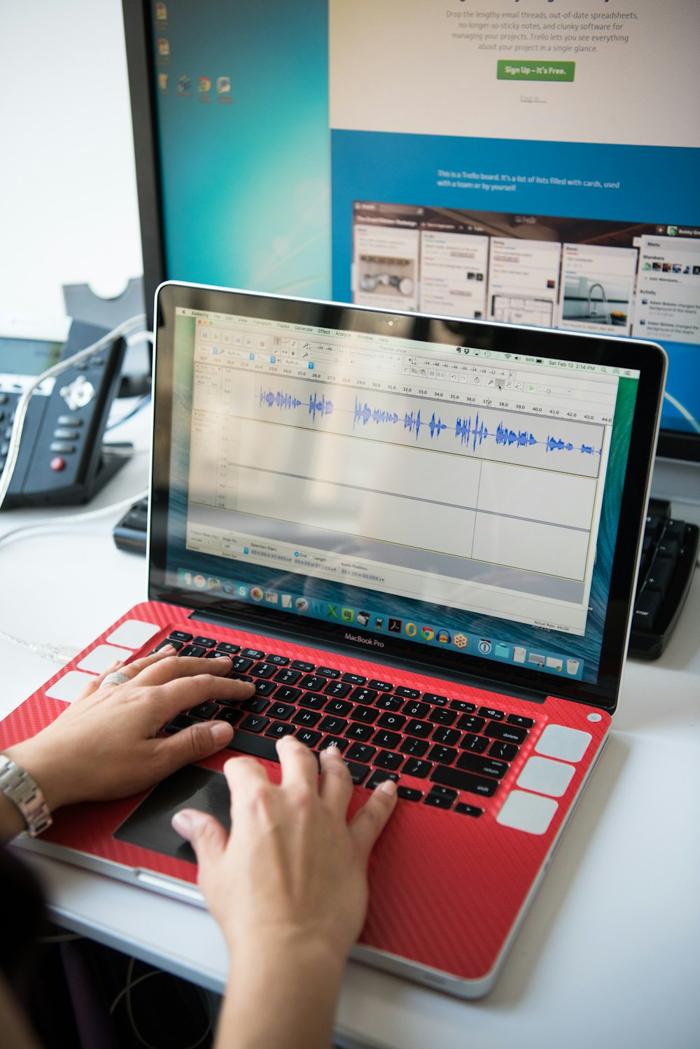 shallow focus photo of person using red laptop computer