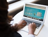 woman using MacBook Air on table