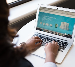 woman using MacBook Air on table