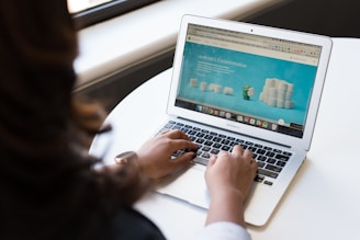 woman using MacBook Air on table