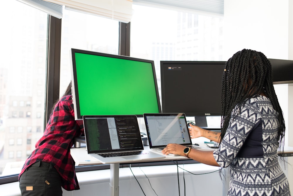 shallow focus photo of woman using laptop computer