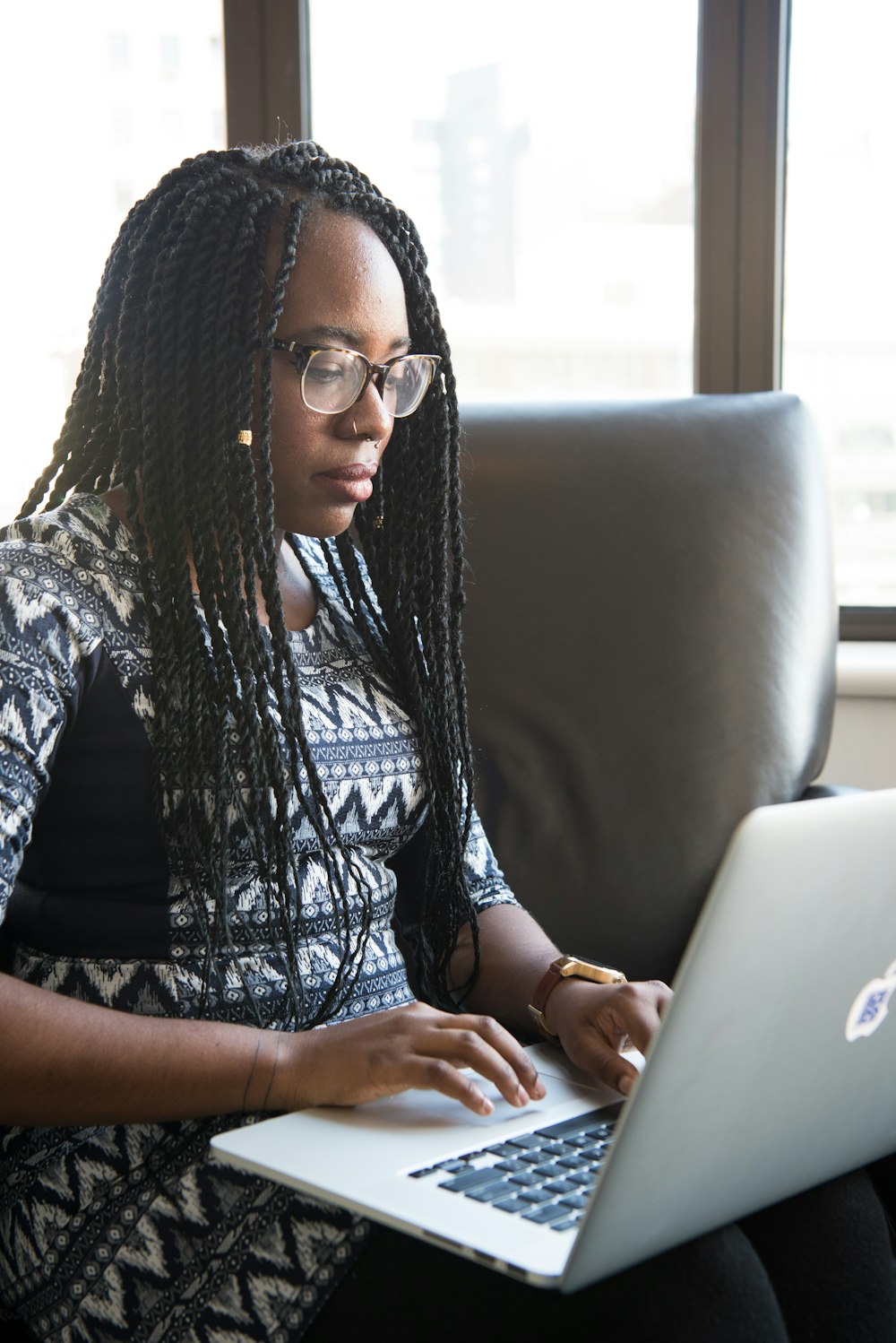 shallow focus photo of woman using MacBook