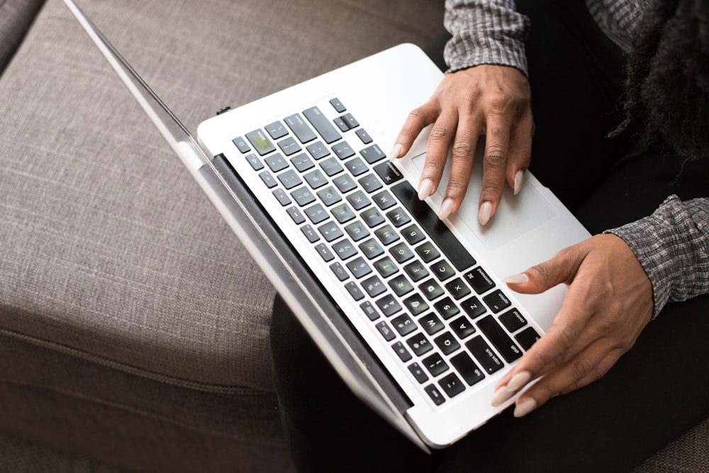 woman facing MacBook