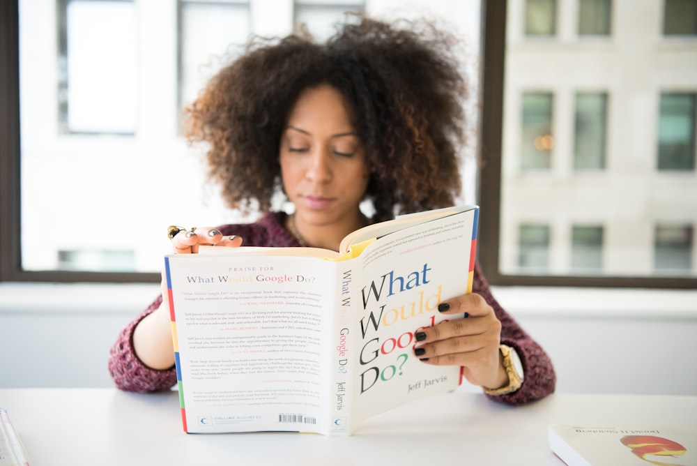 woman reading What Would Good Do? book