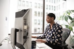 woman using desktop computer
