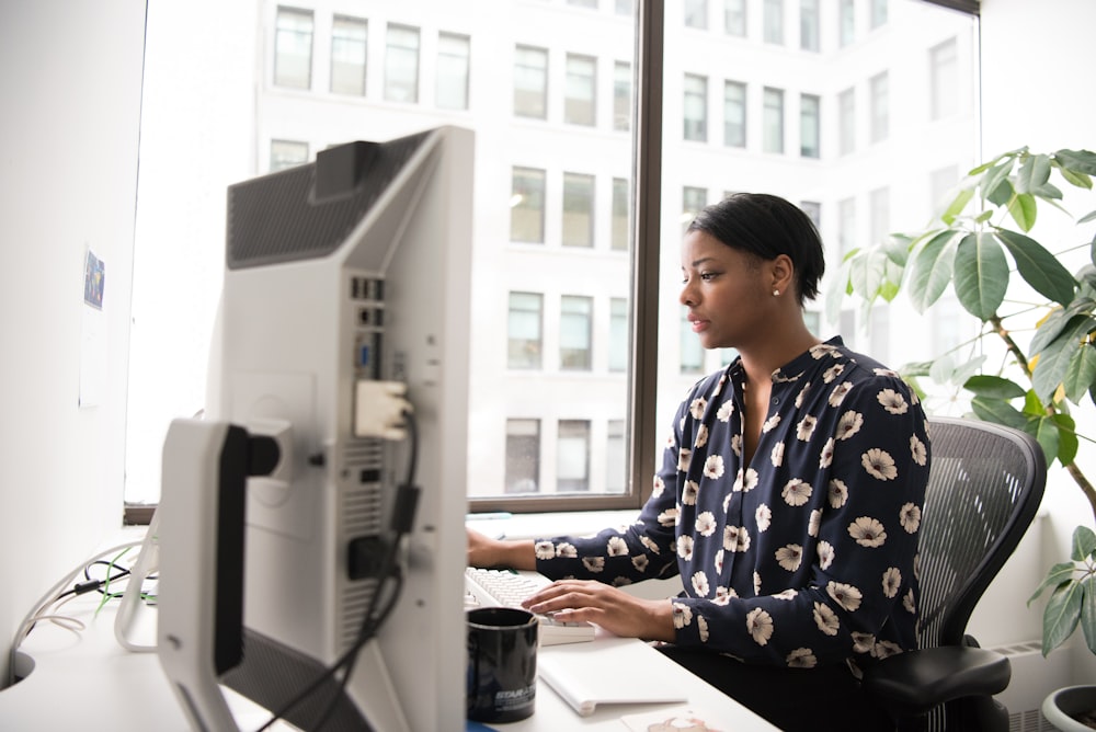 woman using desktop computer