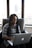 woman using MacBook while sitting on a sofa chair