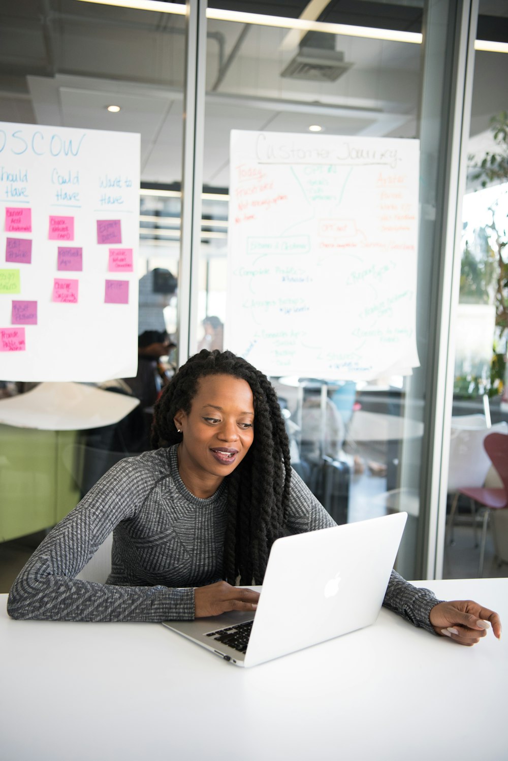 shallow focus photo of woman using gray laptop computer