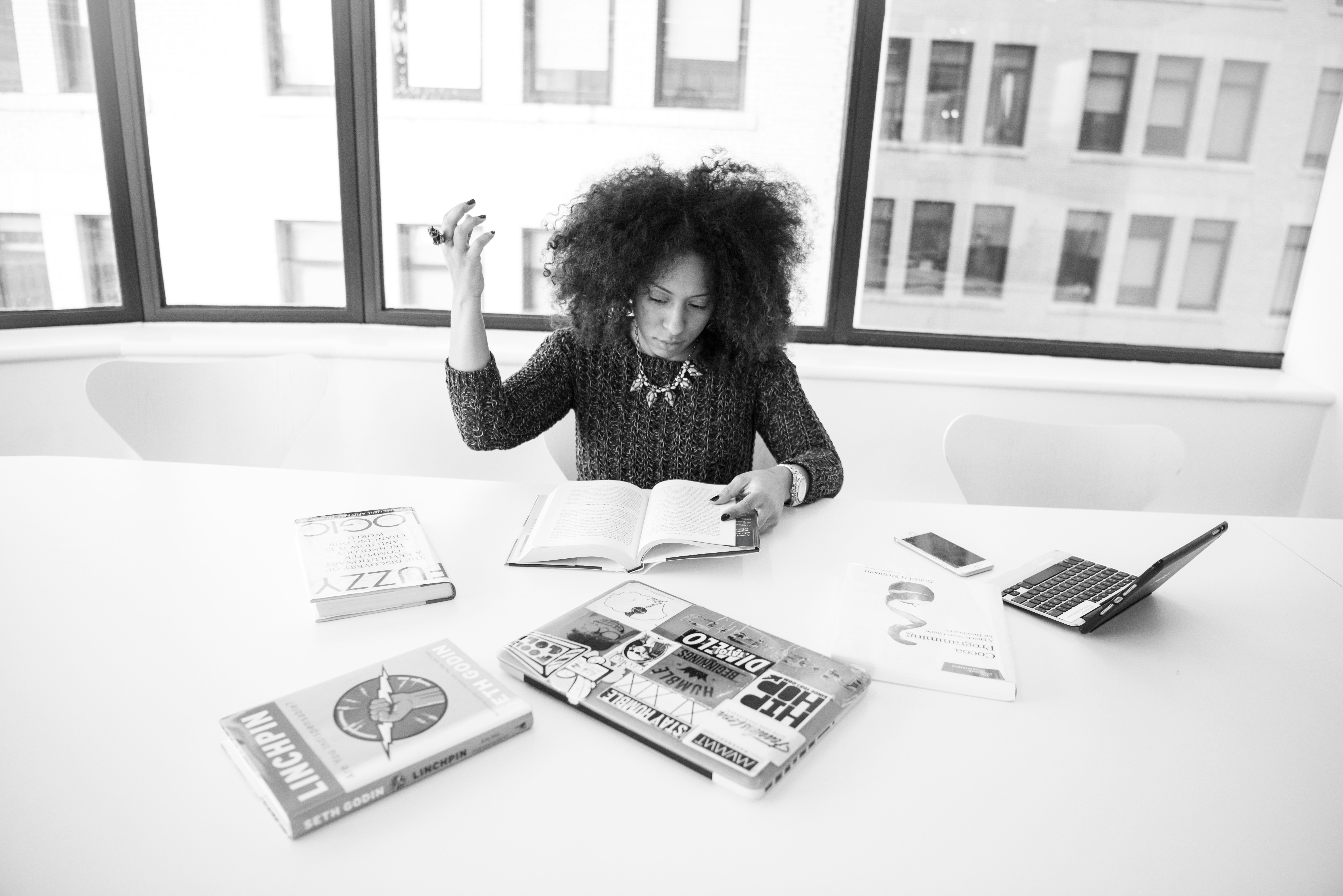 grayscale photography of woman reading book