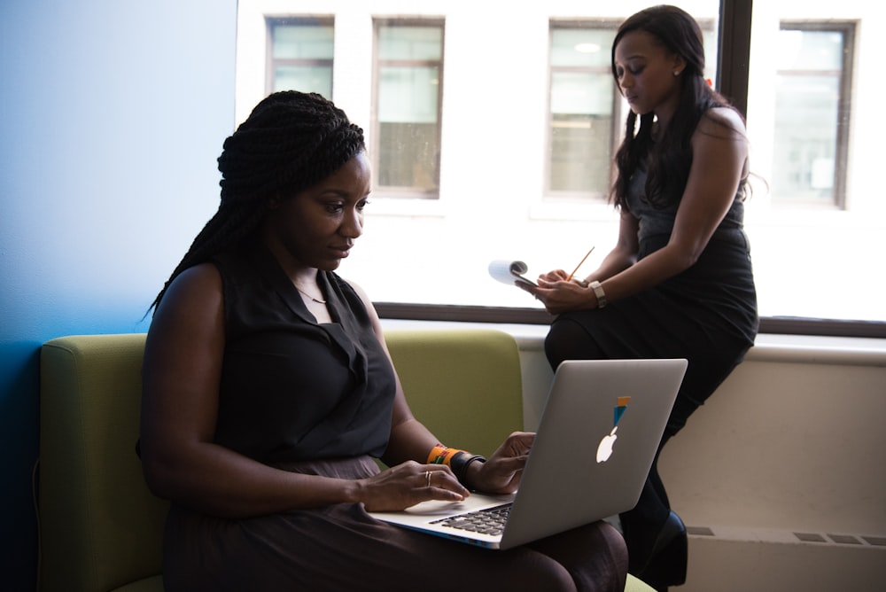 shallow focus photo of woman using MacBook