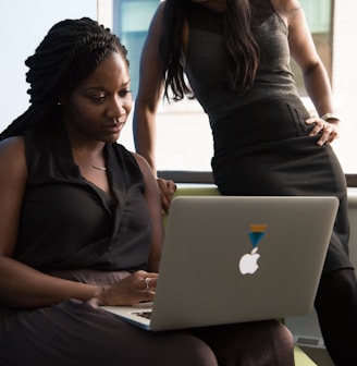 woman sitting infront of MacBook