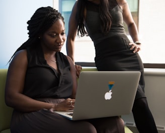 woman sitting infront of MacBook