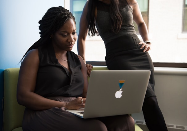 woman sitting infront of MacBook