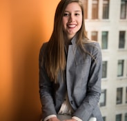 shallow focus photo of woman in gray jacket