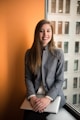 photo of young professional woman in gray jacket