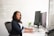 shallow focus photo of woman in black jacket using iMac