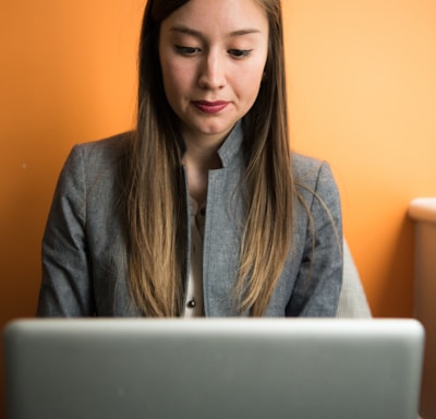 woman looking at MacBook