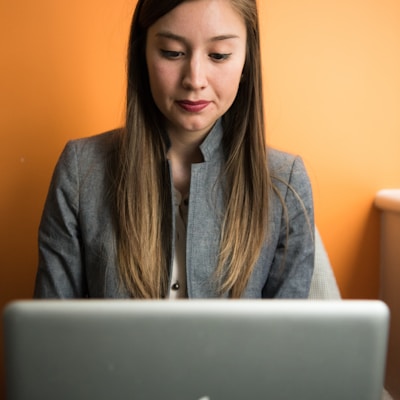 woman looking at MacBook