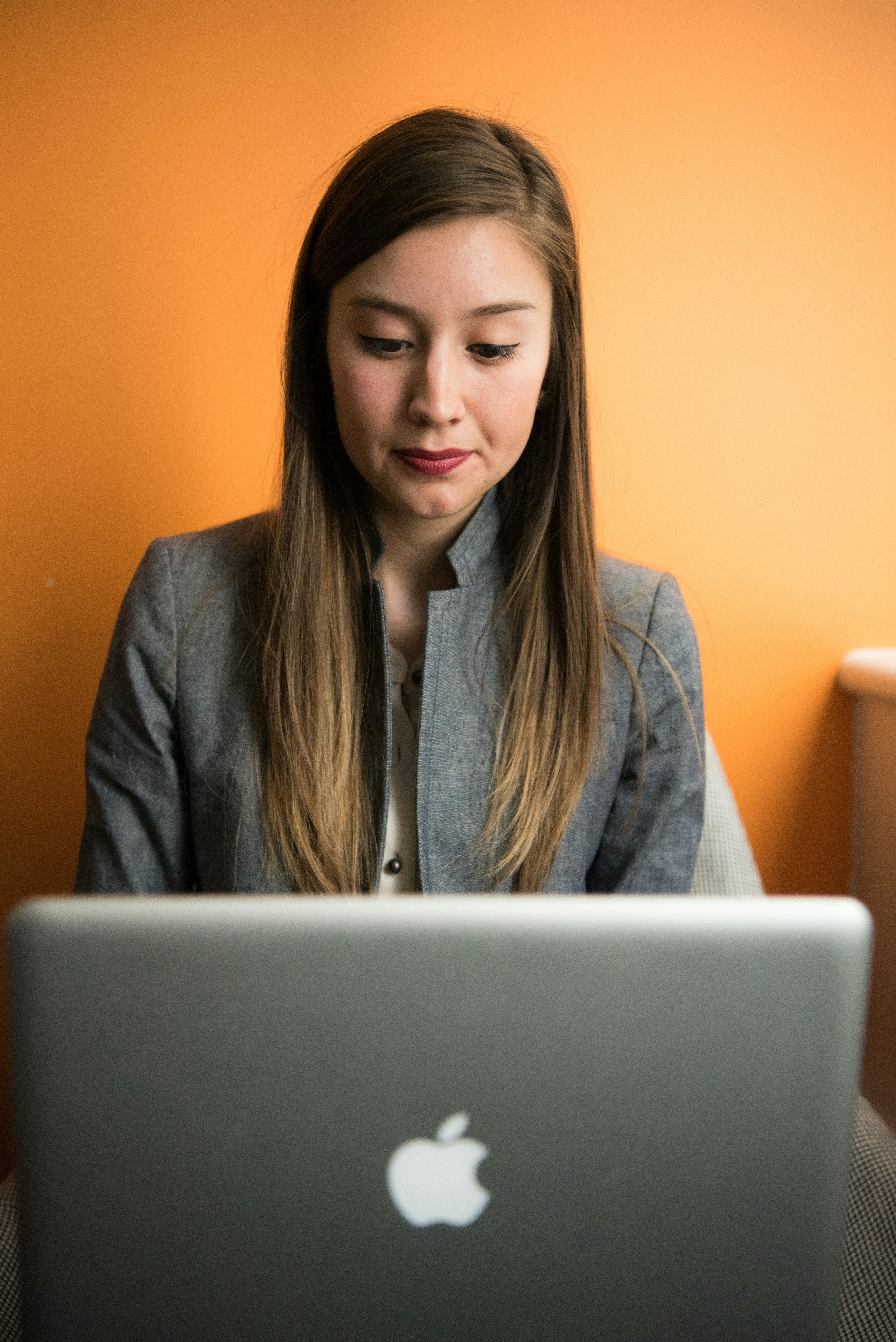 woman looking at MacBook