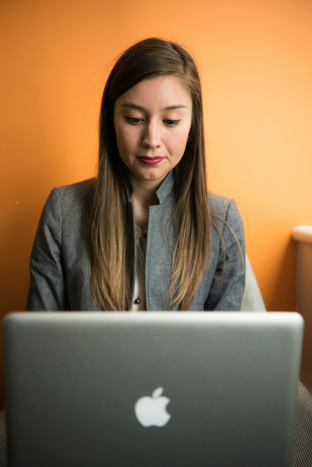 woman looking at MacBook