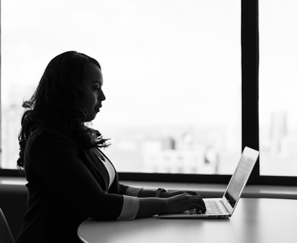 woman sitting and using laptop