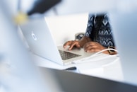 a person using a laptop computer on a desk