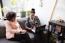 two woman siting on sofa inside room