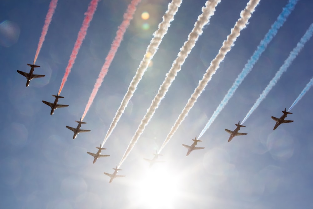 a group of airplanes flying through a blue sky