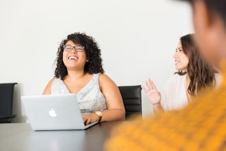 woman sitting in front of the laptop
