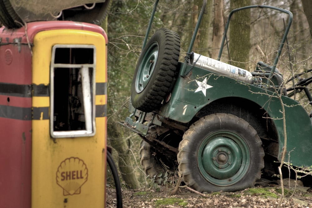 green vehicle beside trees