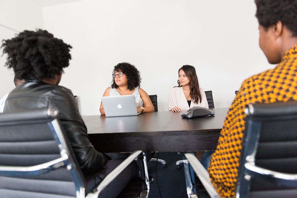 four women sitting at table