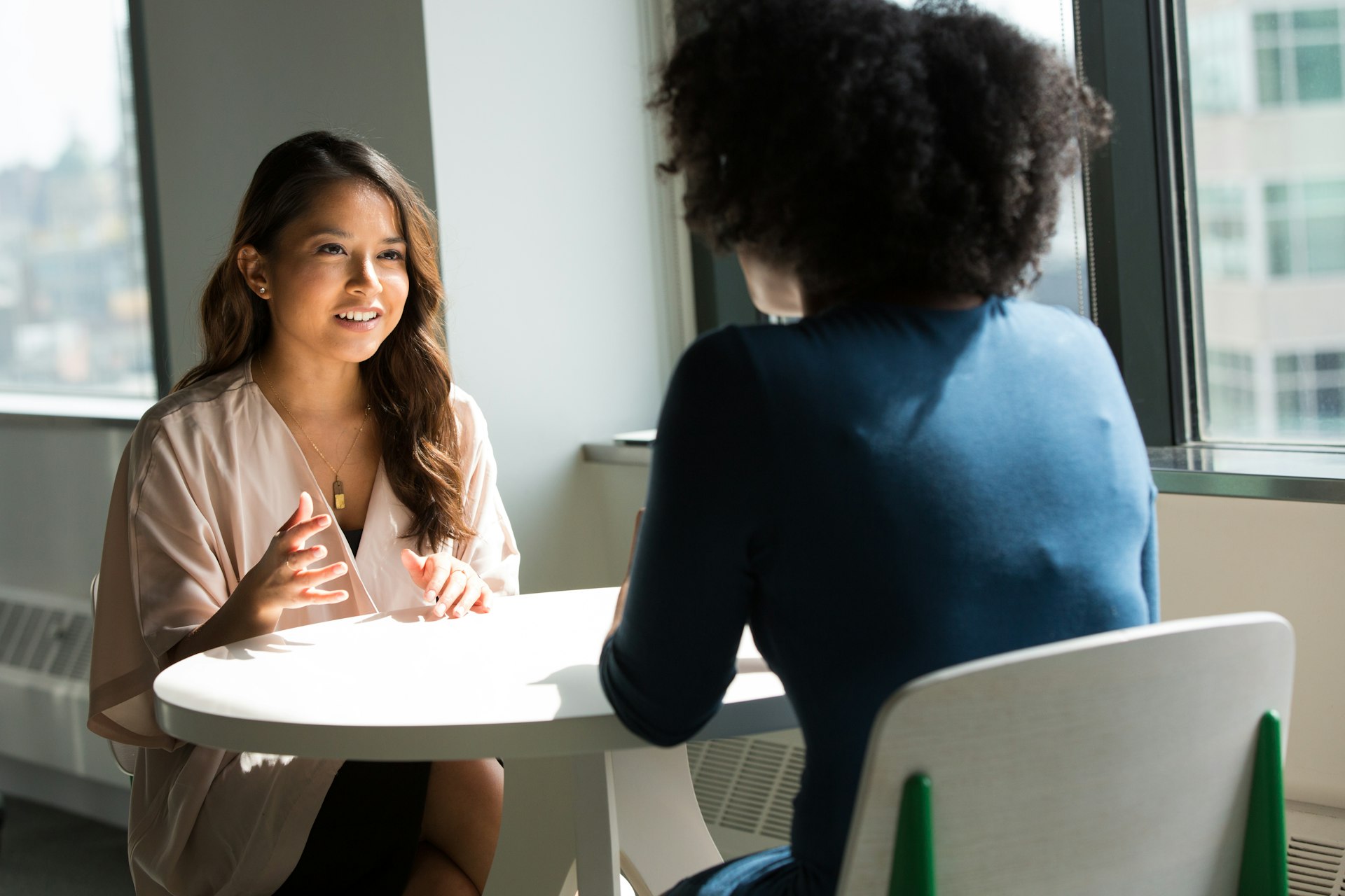 Image showing two women conversing together in a meeting