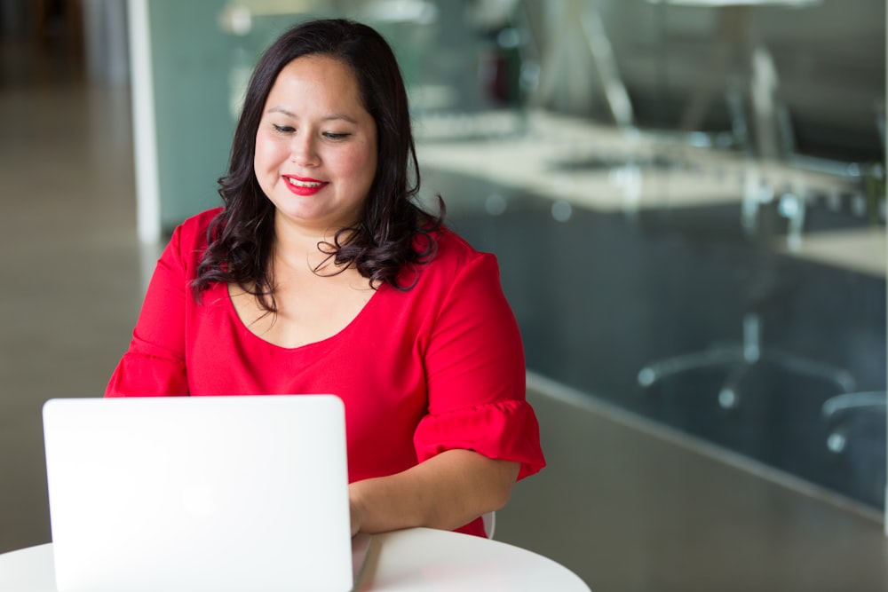 selective focus photography of woman using laptop computer