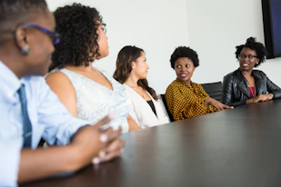 Business meeting with diverse professionals discussing strategy around a table.