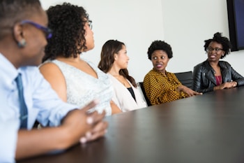 A diverse group of professionals engaged in a discussion around a table.