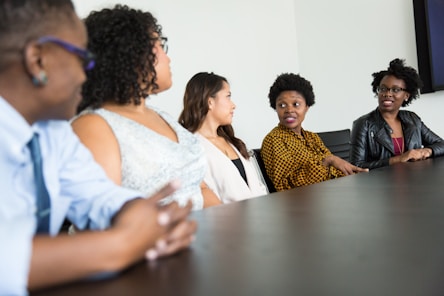 A group of diverse professionals discussing a project around a conference table.