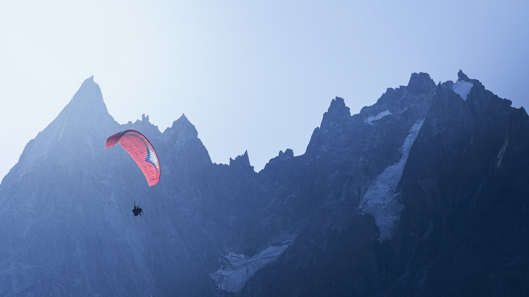 Man parachuting in the mountains