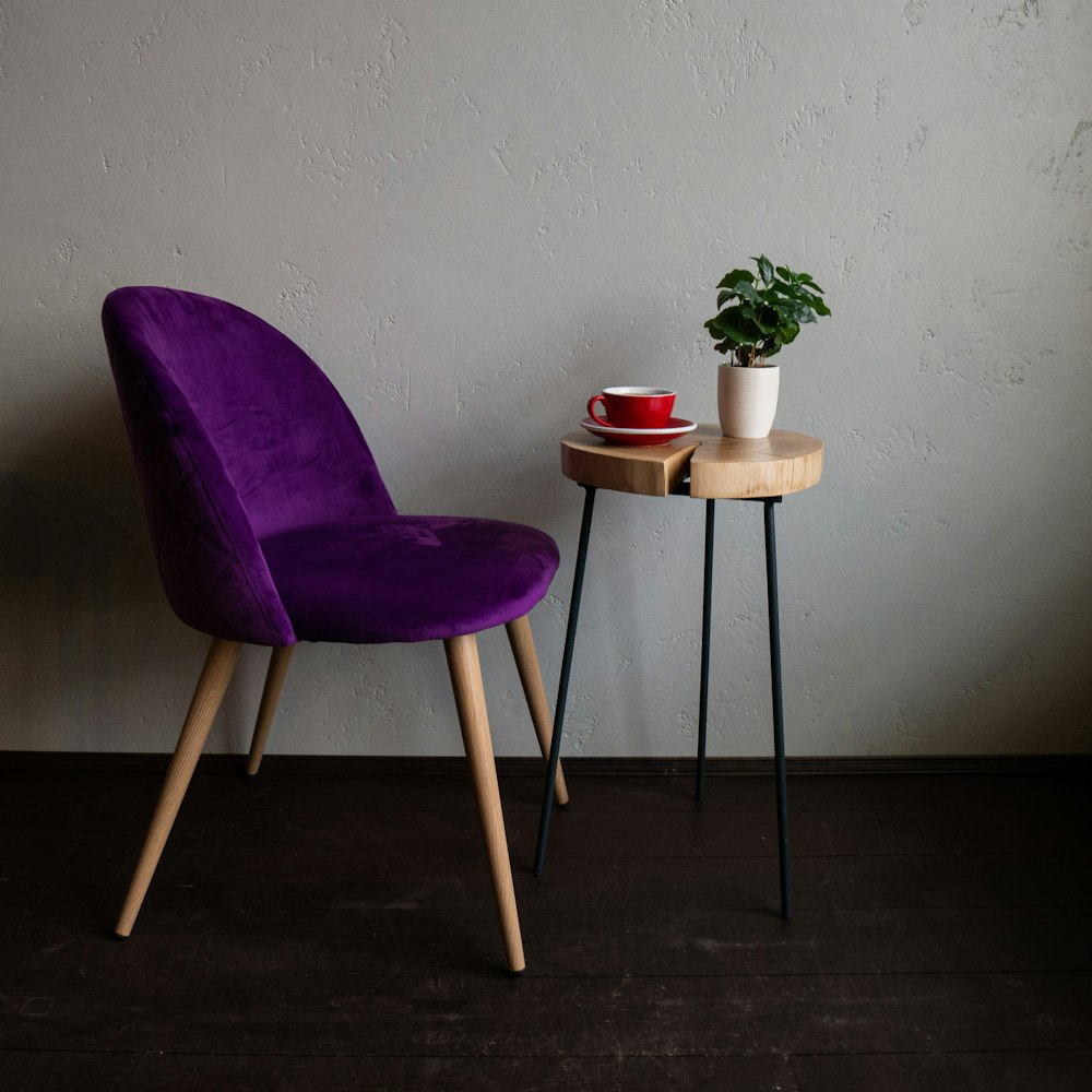 purple armless chair and brown wooden table