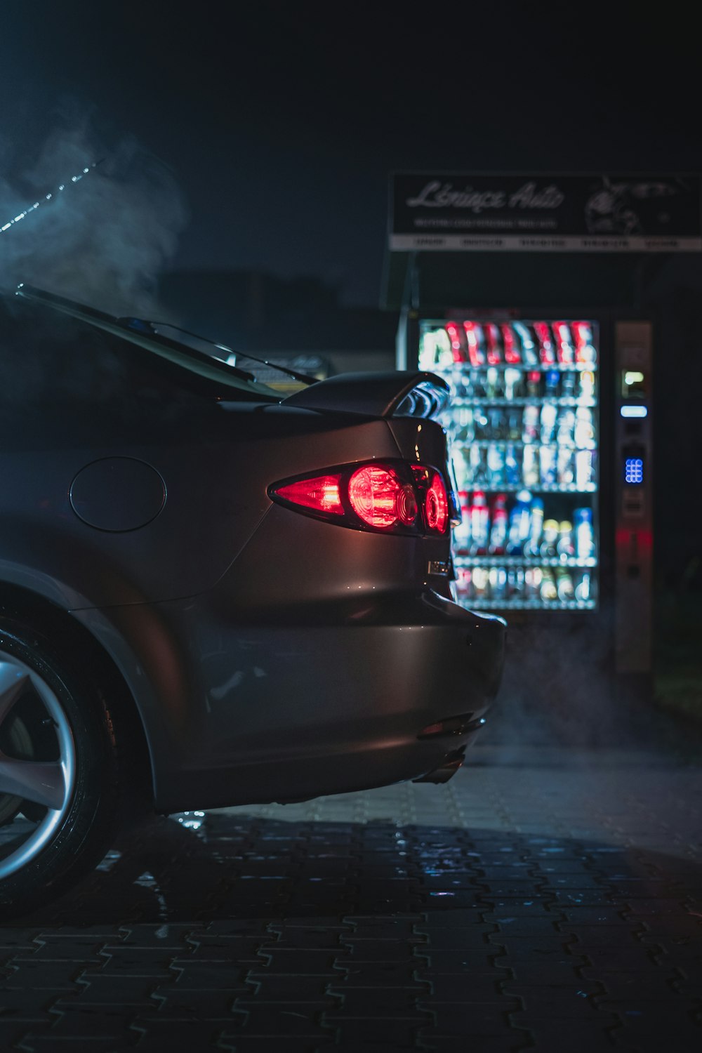 gray vehicle parked beside vending machine