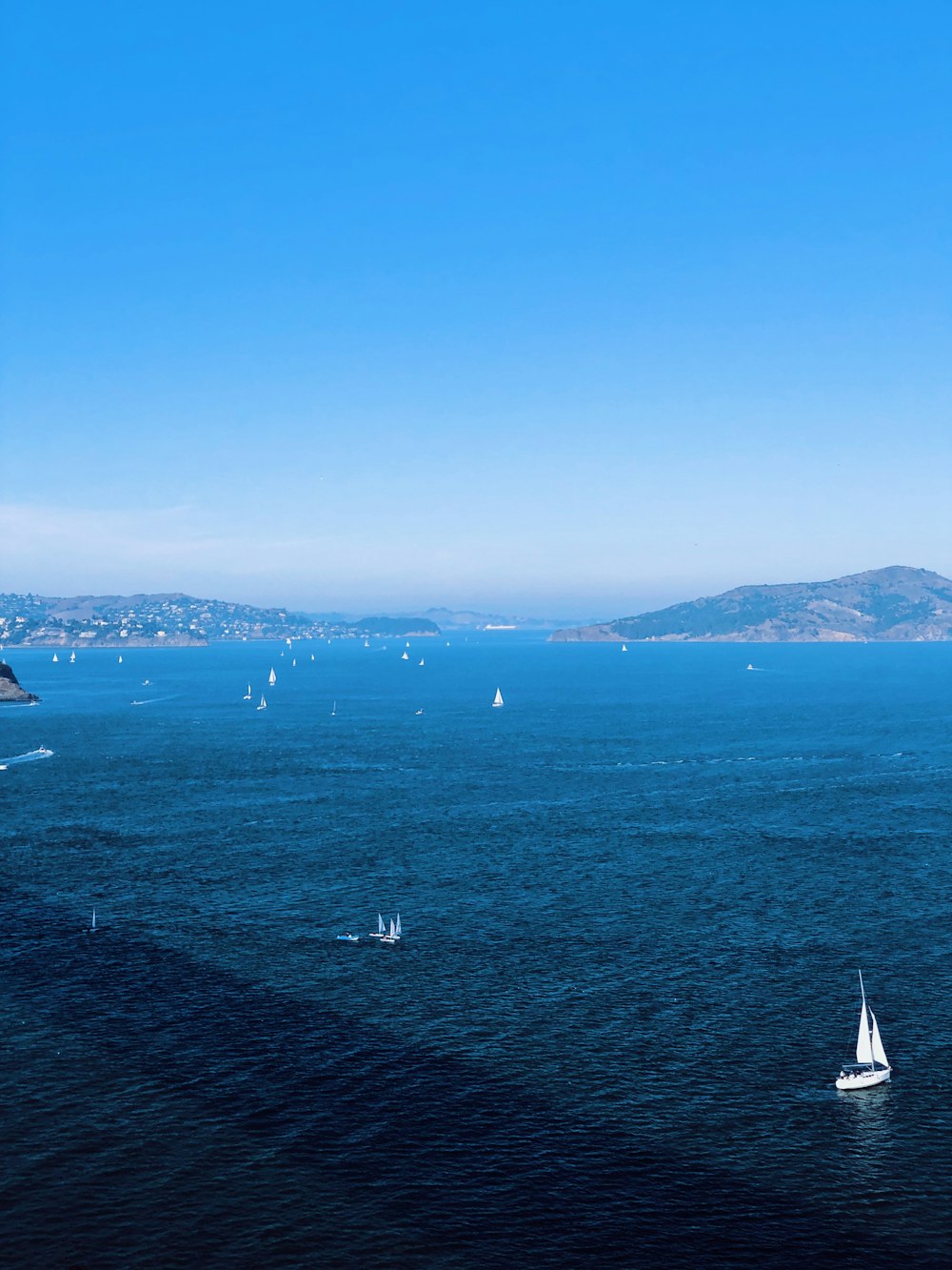 white sailboat on body of water during daytime