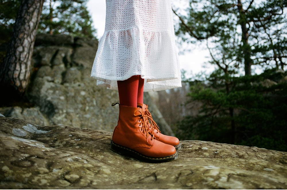 person wearing brown work boots