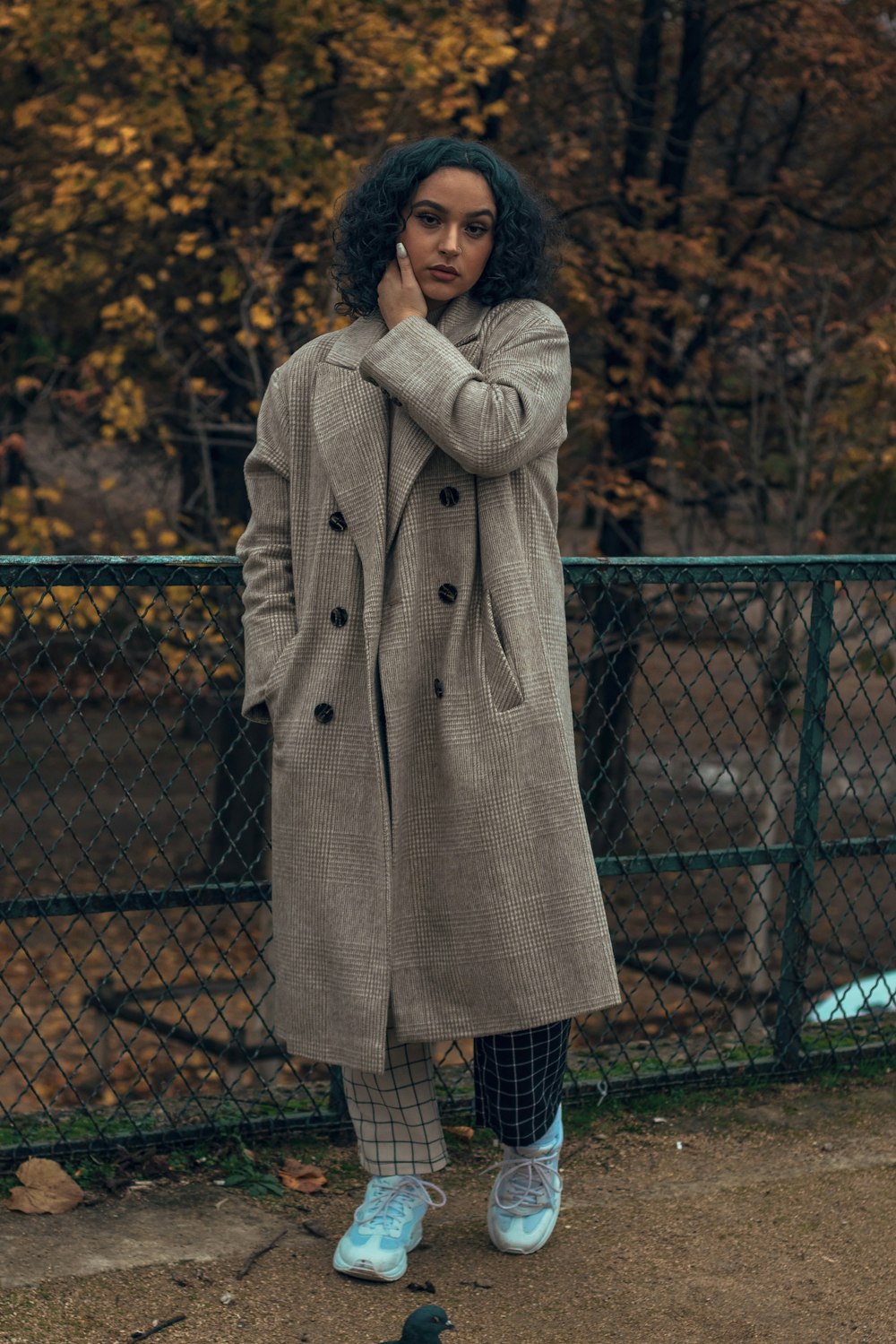 woman wearing gray trench coat