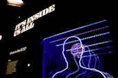 a neon display of a man's head and brain