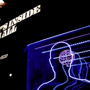 a neon display of a man's head and brain