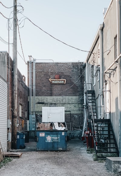 Blue dumpster in back alley