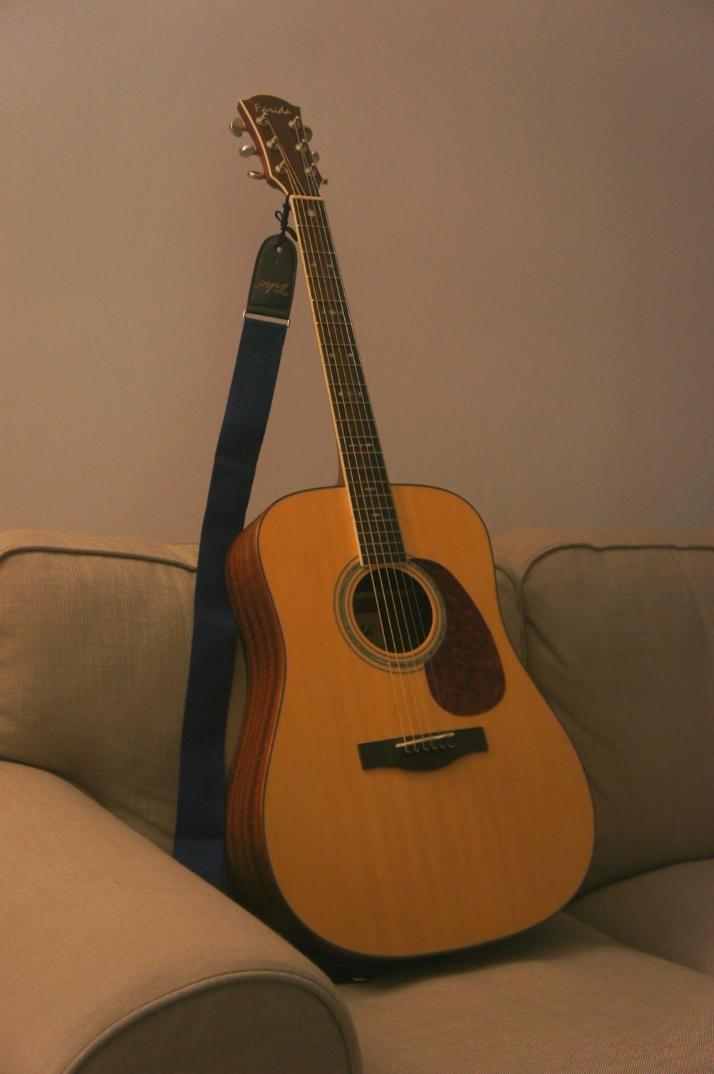 acoustic guitar on sofa